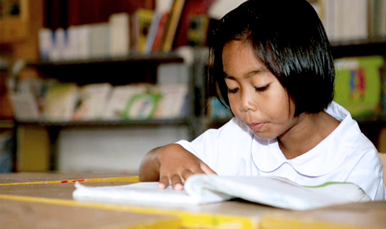 SOS-Archiv-SOS-Kinderdorf-Mädchen liest in einem Buch